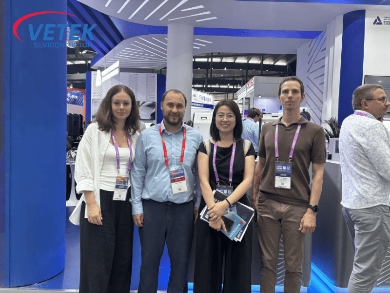 Vetek Semiconductor leadership posing for a photo with exhibiting clients.